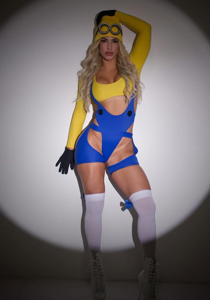 Person wearing a yellow and blue minion inspired outfit with goggles on a plain background