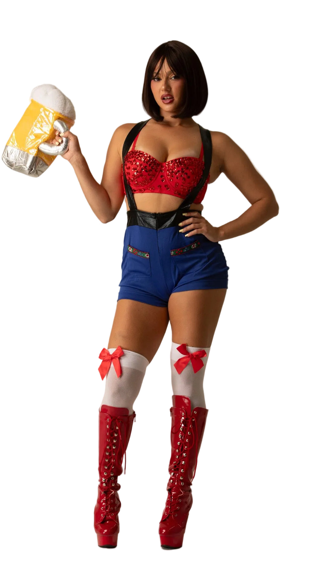 A woman modeling an October fest beer red and blue costume outfit with a red sequined bra top, blue shorts, white thigh-high socks with red bows, and red platform boots, while holding a beer mug prop against a plain beige studio background.
